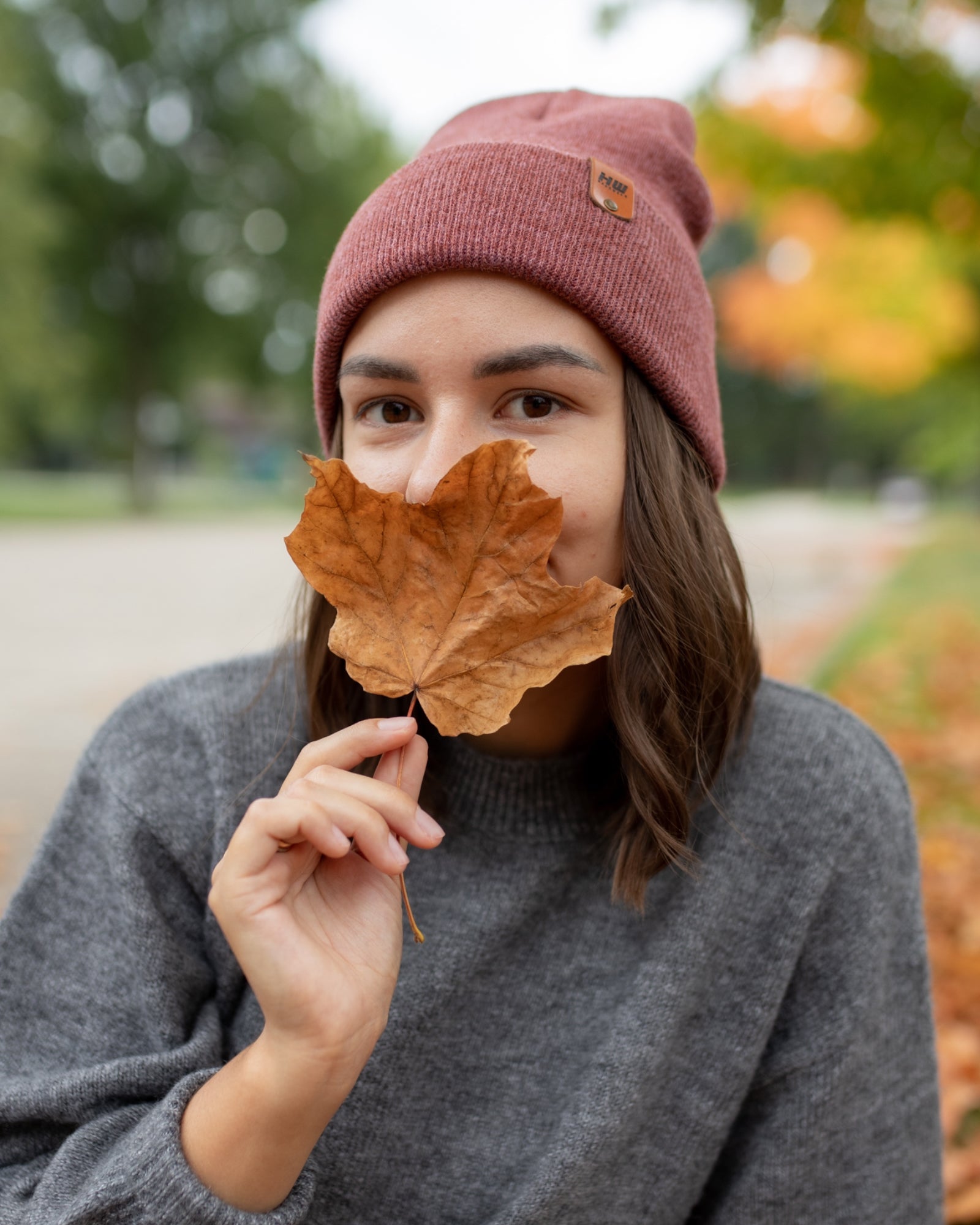 Azure Arrowwood HAAKWEAR knit cuffed beanie in rusty burgundy, featuring a cozy, textured knit hat style and snug cuff design.