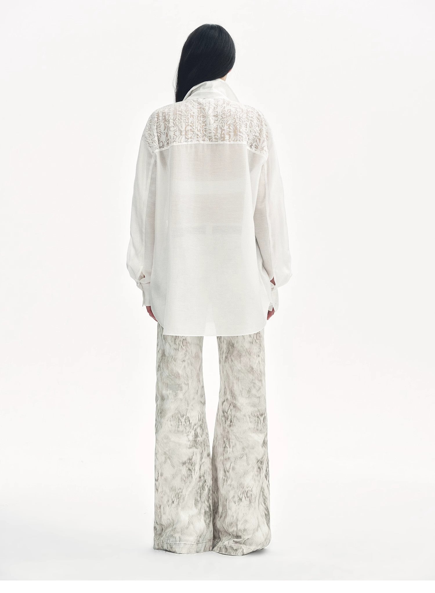 Brown Coeus Phantom snake print flared denim trousers with a stylish, fitted design and unique snake pattern.