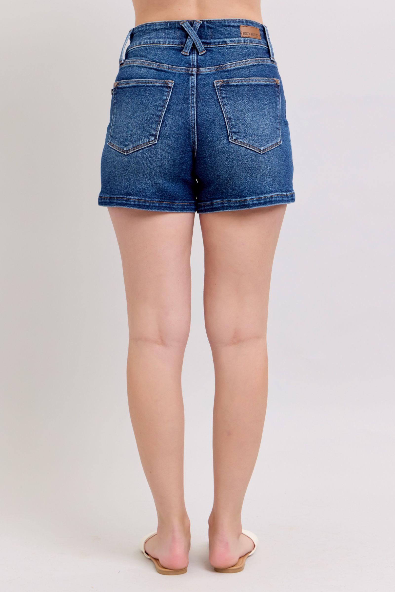 Judy Blue plus size denim shorts with double button waistband, featuring a classic denim design and visible stitching.