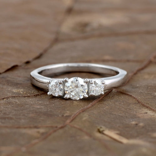 Sterling silver white moissanite 3-stone ring showing three sparkling stones set in a sleek band, elegant jewelry design