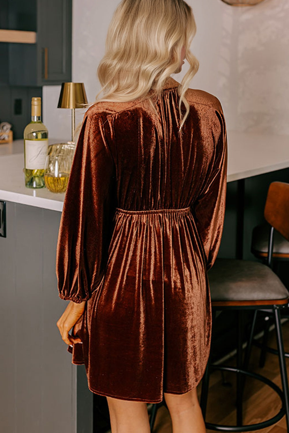 Velvet elastic V-neck mini dress with puff sleeves by Byzantium Bay, shown in a stylish, close-up view.