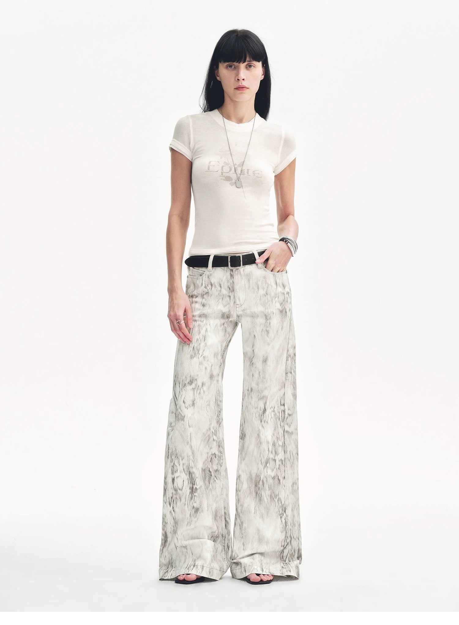 Brown Coeus "Phantom" snake print flared denim trousers, showcasing the textured snake pattern and stylish flared cut.