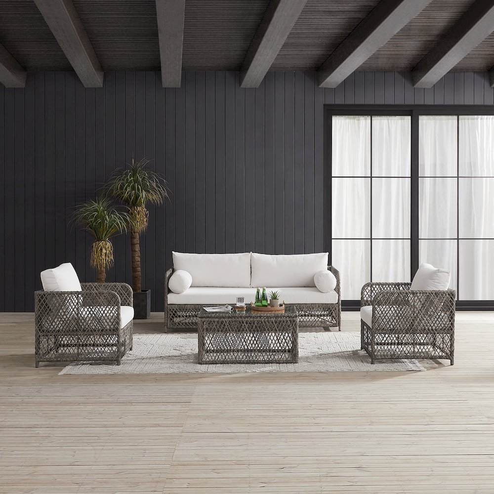Granite Bay 4-piece outdoor sofa patio furniture set by Start2Finish with a sofa, coffee table, and two chairs on a patio.