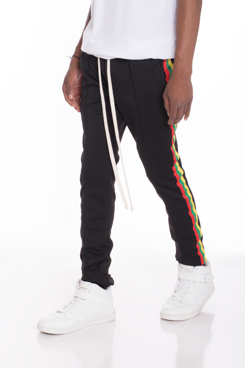 Black Rasta track pants by Lime Milo featuring bold Rastafarian-inspired patterns and comfortable athletic fit.