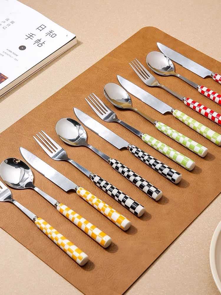 Six modern checkered flatware sets by Inspecial Home, featuring sleek design for home decor and table setting.