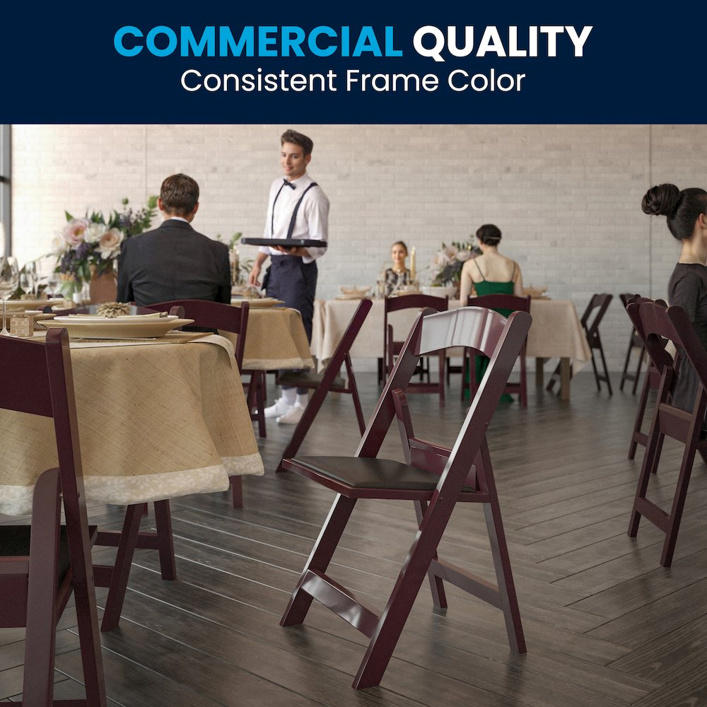 Two red mahogany resin folding chairs with black padded vinyl seats, featuring 1000 lb. capacity from HERCULES Series by Start2Finish.