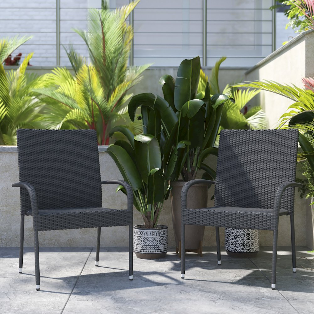 Pair of gray stackable wicker dining chairs with armrests and weather-resistant steel frames for indoor or outdoor use.