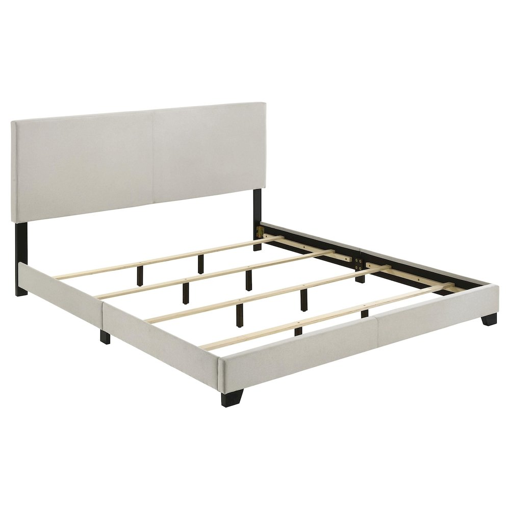 Cream fabric upholstered Eastern King panel bed by Start2Finish with a sturdy wooden frame and modern design.