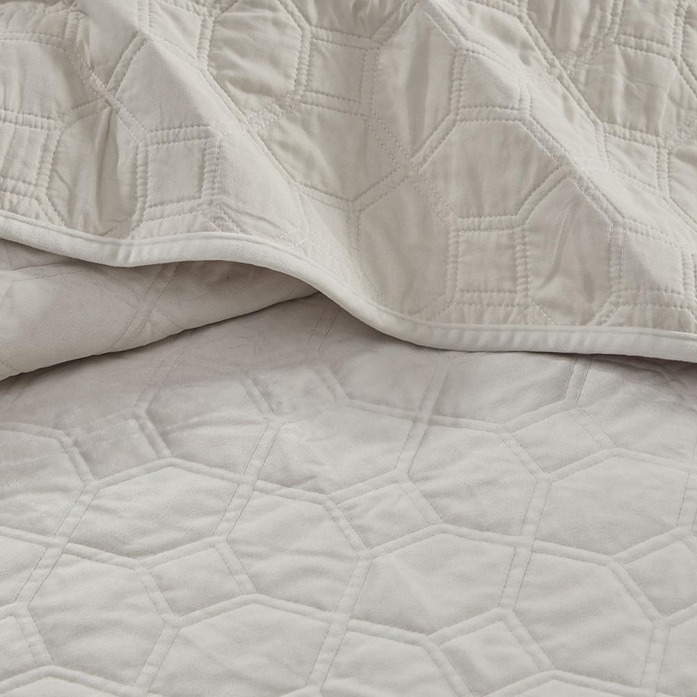 Start2Finish Harper 3-piece velvet quilt set in ivory, including a quilt and matching pillow shams, displayed on a bed.