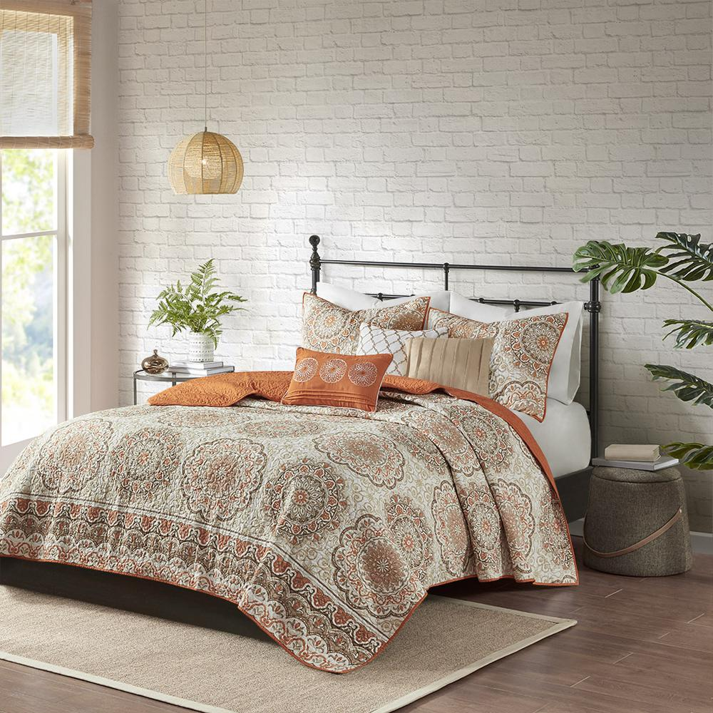 Start2Finish 6-piece reversible quilt set with matching throw pillows on a bed, featuring colorful geometric patterns.