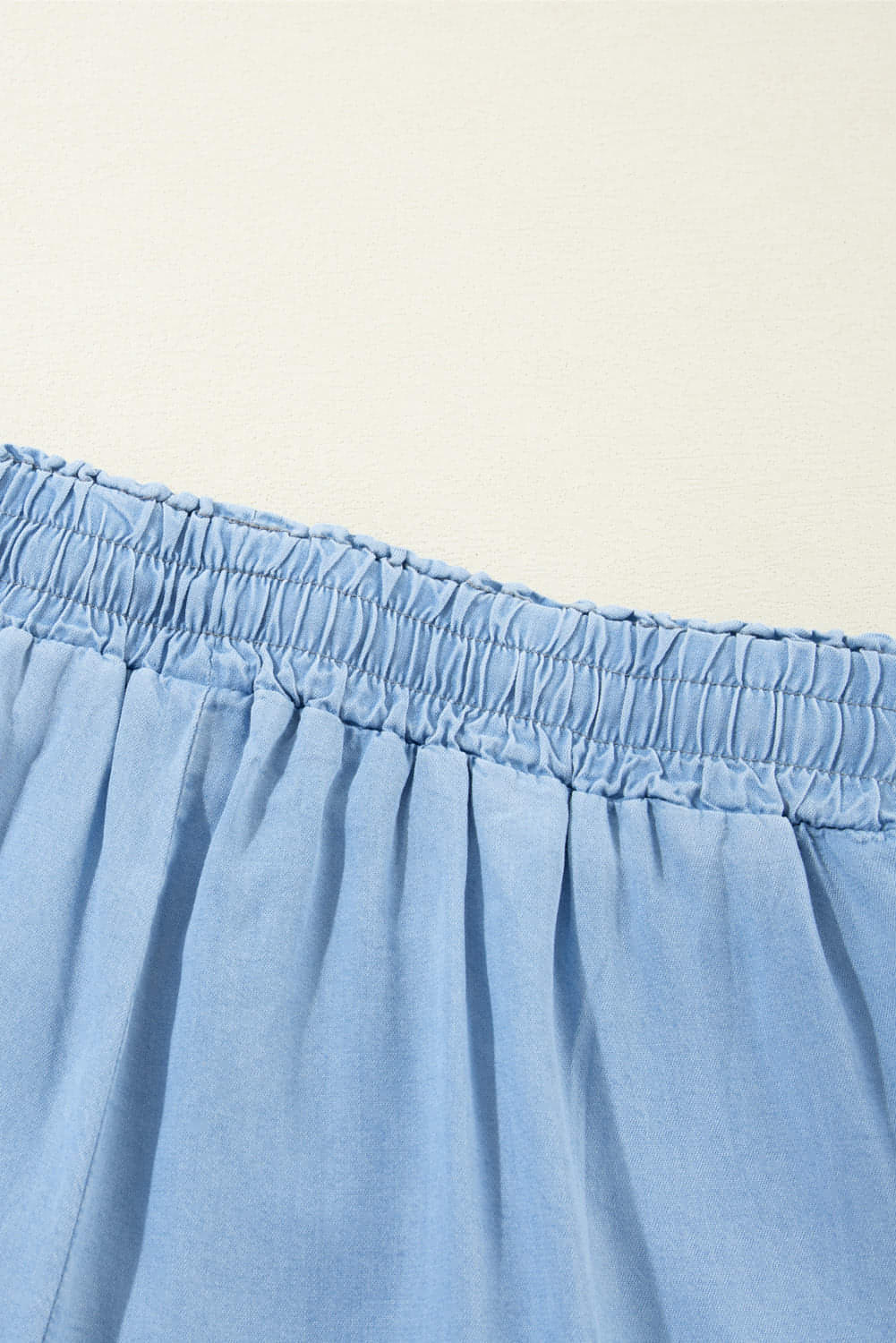 Carmine Juneberry Myosotis high waist wide leg denim pants with drawstring waist and classic blue denim fabric.