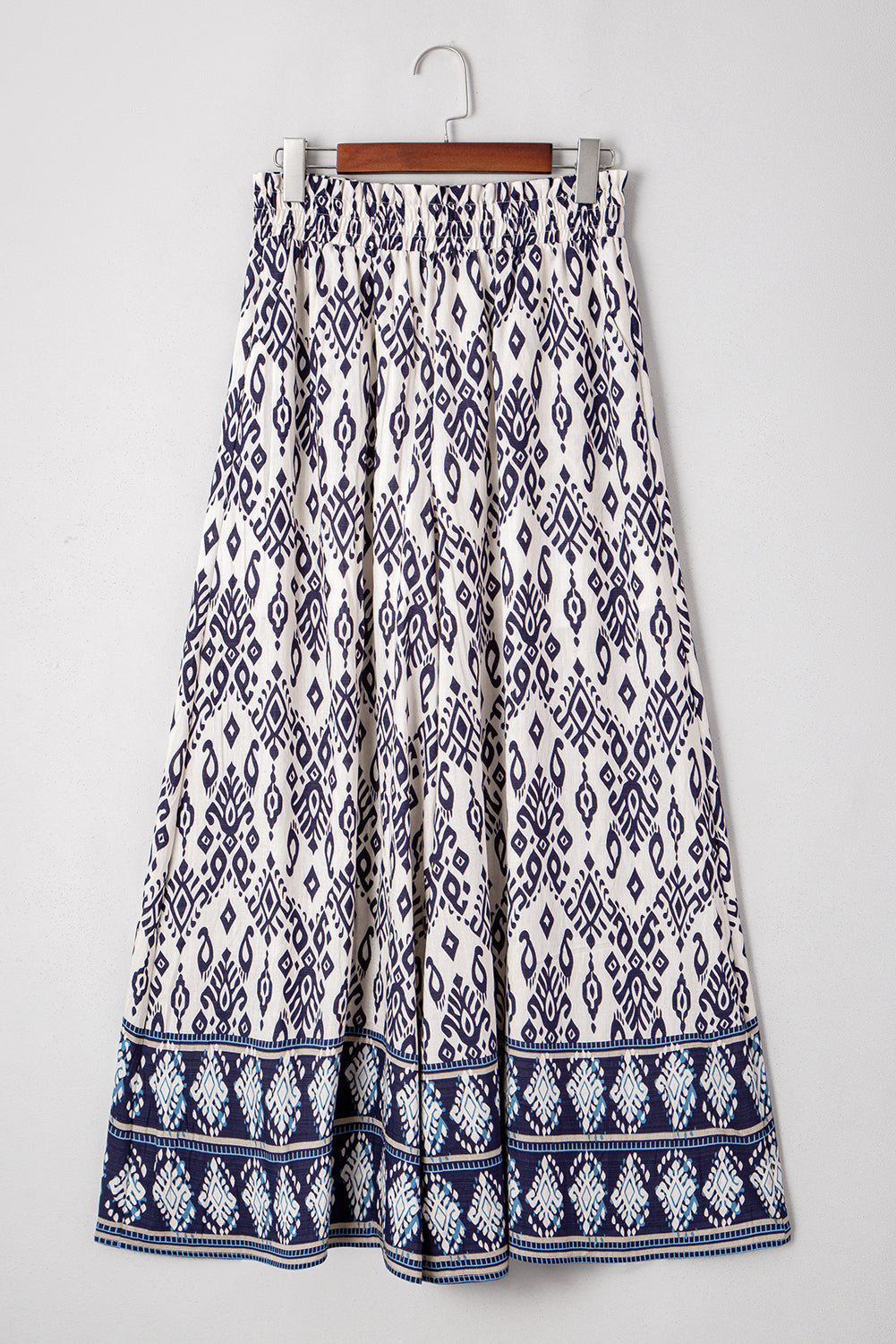 Byzantium Bay boho smocked high waist wide-leg pants for women, featuring flowy fabric and relaxed fit.