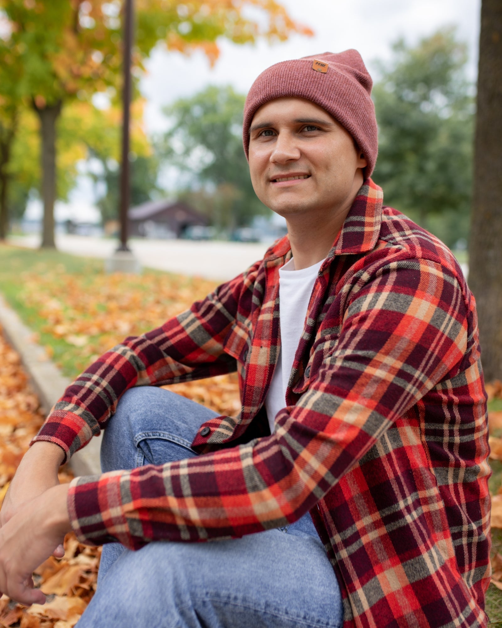 Azure Arrowwood HAAKWEAR knit cuffed beanie in rusty burgundy, featuring a cozy knit design and cuffed style for warmth and style.