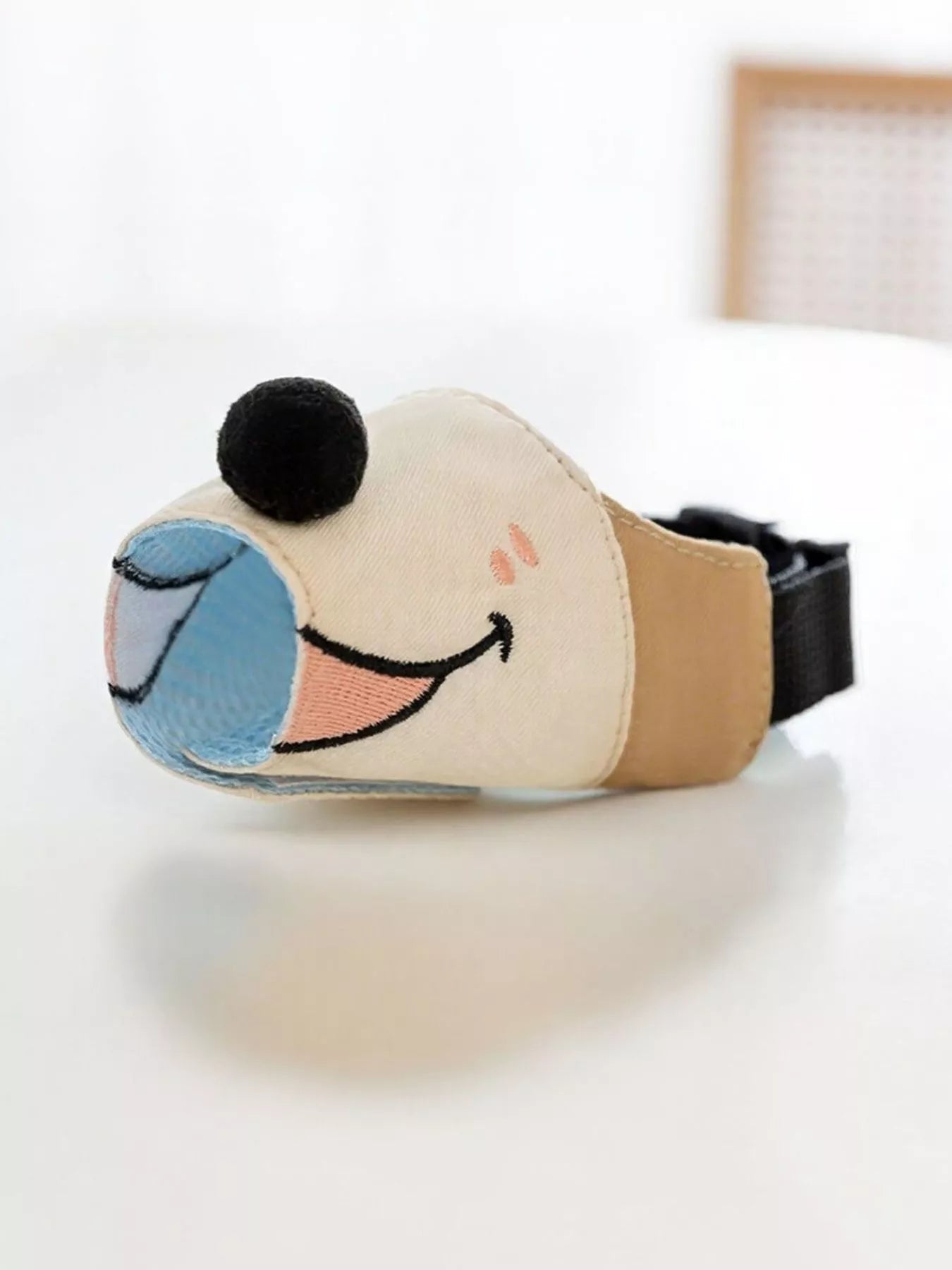 Pear Daisy anti-bite dog muzzle in black, designed to prevent biting and ensure safety during walks or grooming.