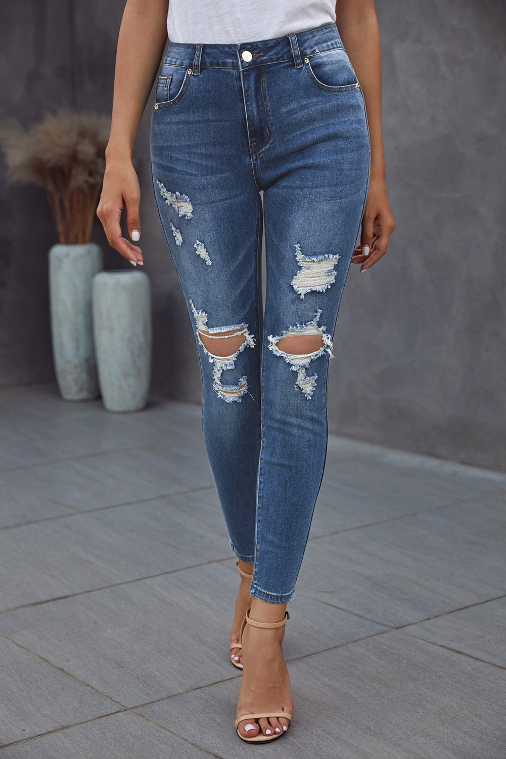 Blue hollow-out vintage skinny ripped jeans by Harlequin Daisy, showing distressed denim with ripped details and slim fit style.