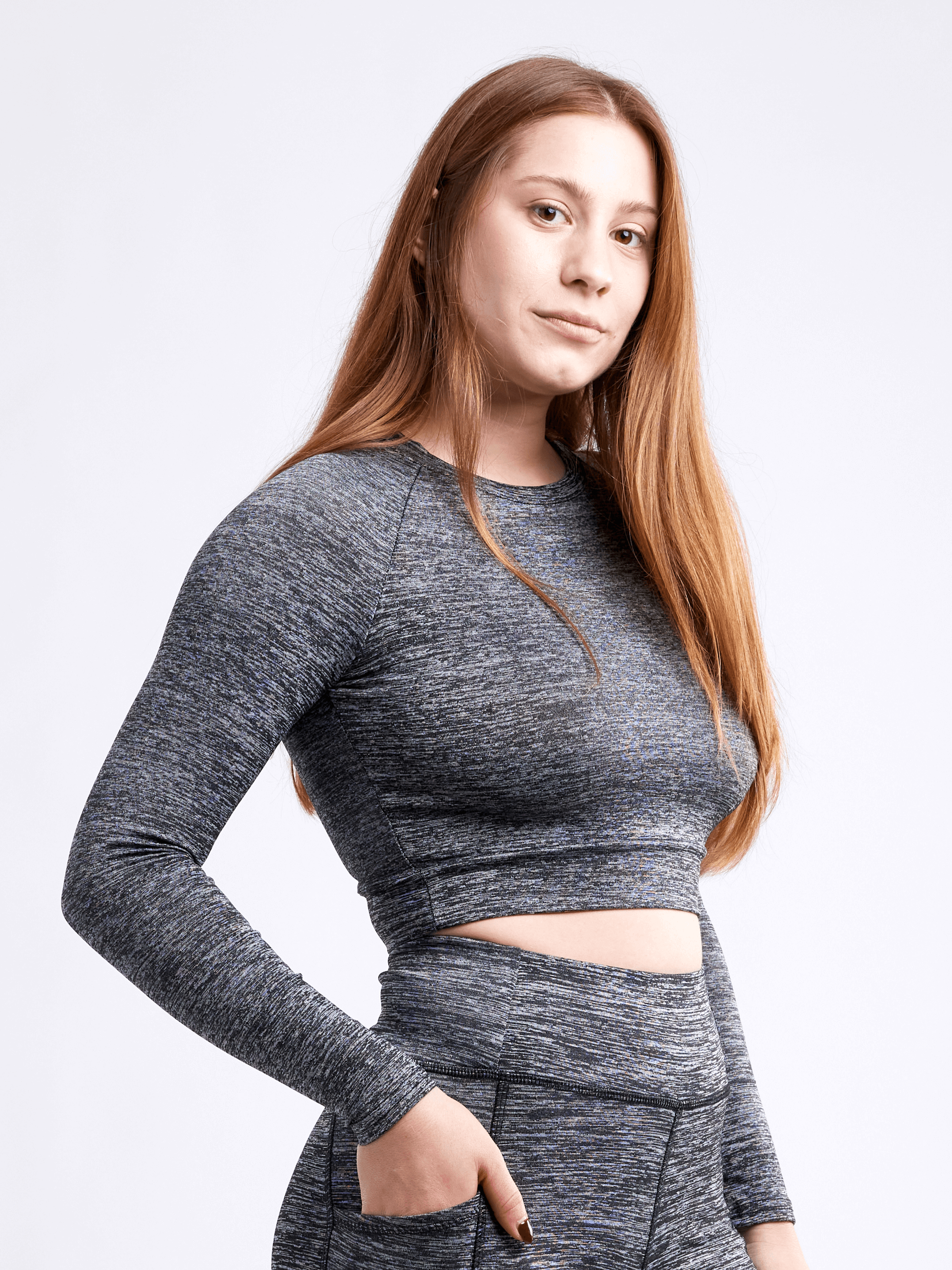 Black Lavender JupiterGear long-sleeve crop top, activewear with a fitted style, shown on a model in a gym setting.