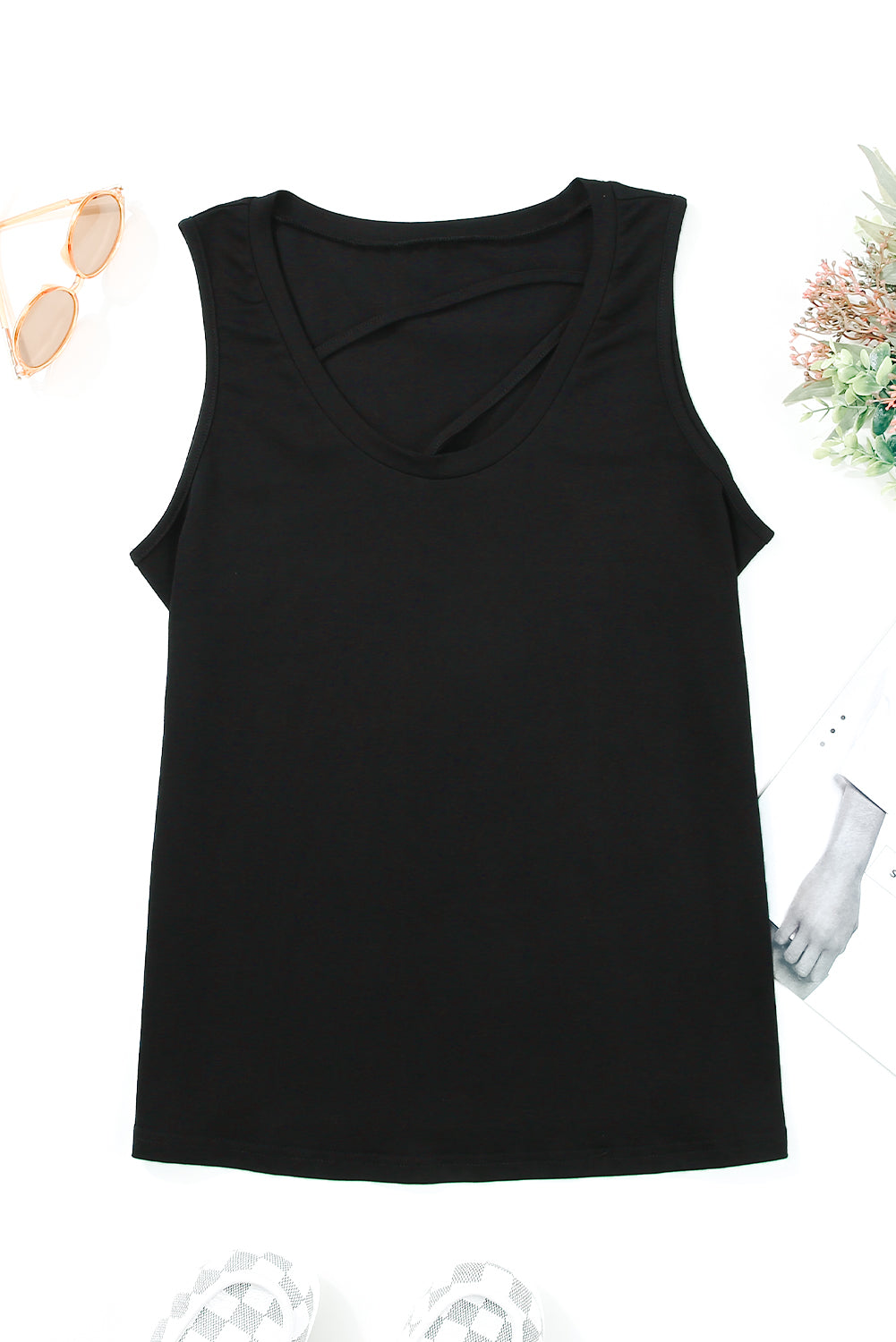 Black strappy hollow-out neck tank top by Harlequin Daisy, casual fashion piece with stylish cutouts and slim straps.
