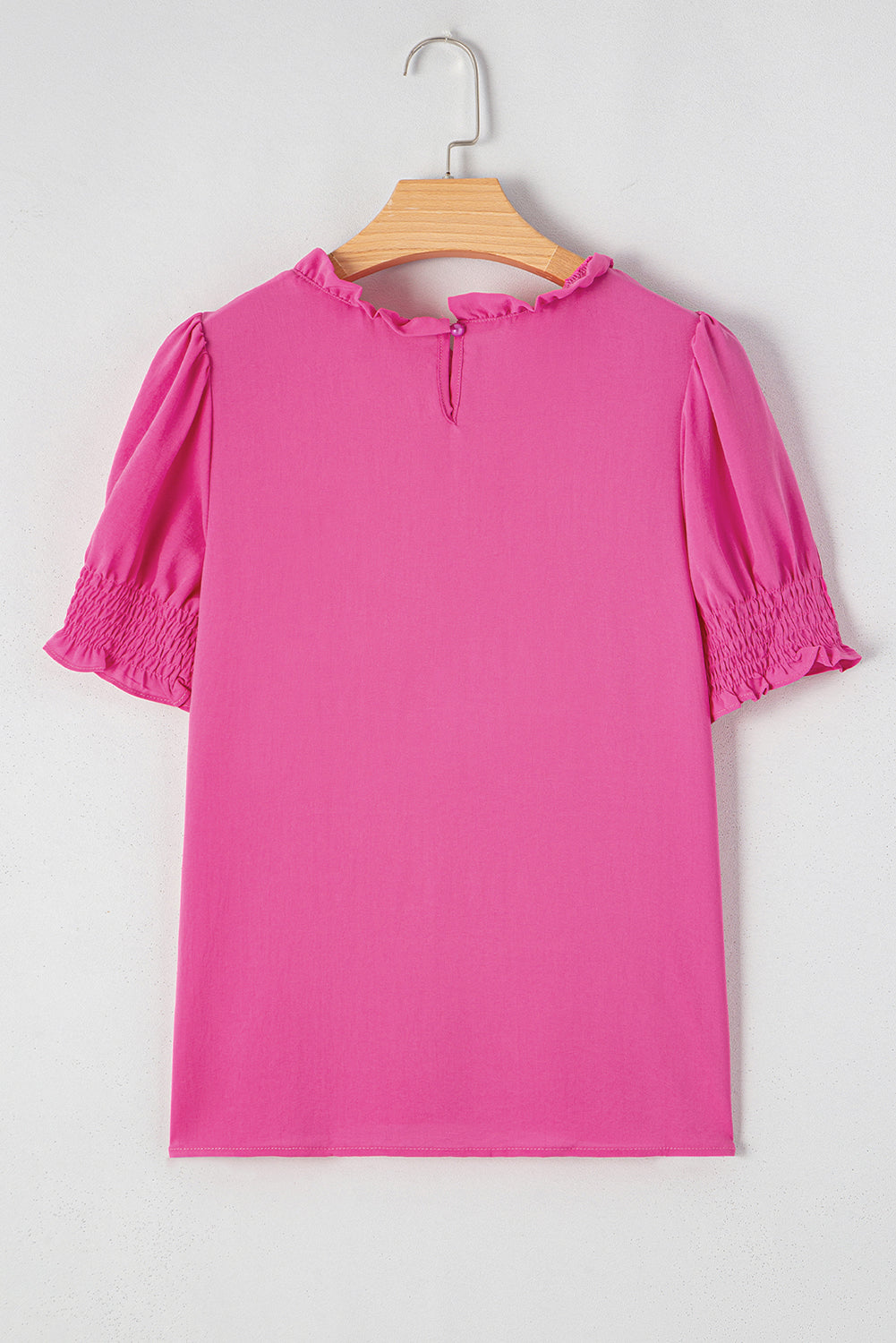 Pink rose solid color smocked puff sleeve blouse by Carmine Juneberry, featuring a feminine design with puffed sleeves and a fitted bodice.