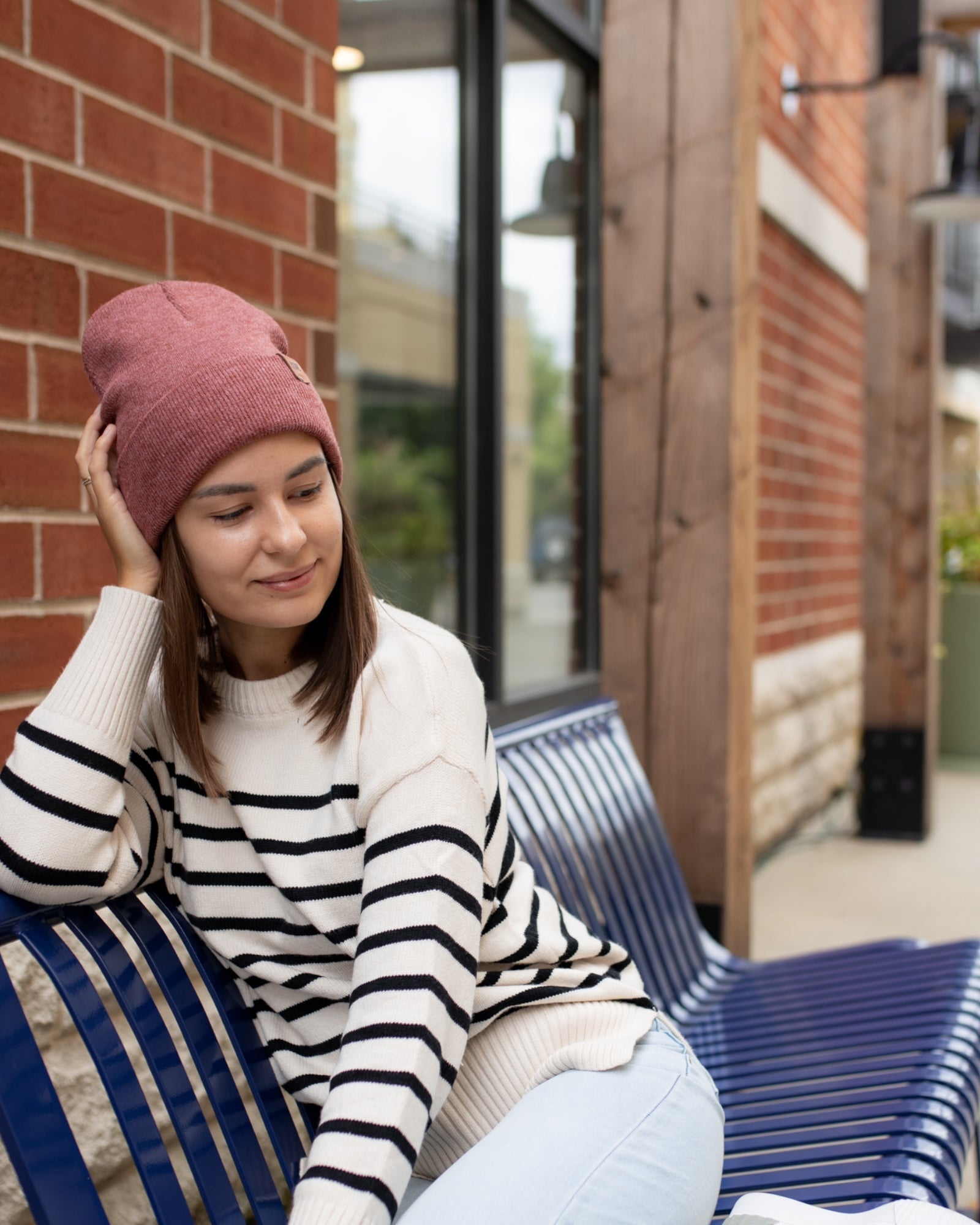 Azure Arrowwood HAAKWEAR knit cuffed beanie in rusty burgundy, close-up view showing soft knit fabric and cuffed brim.