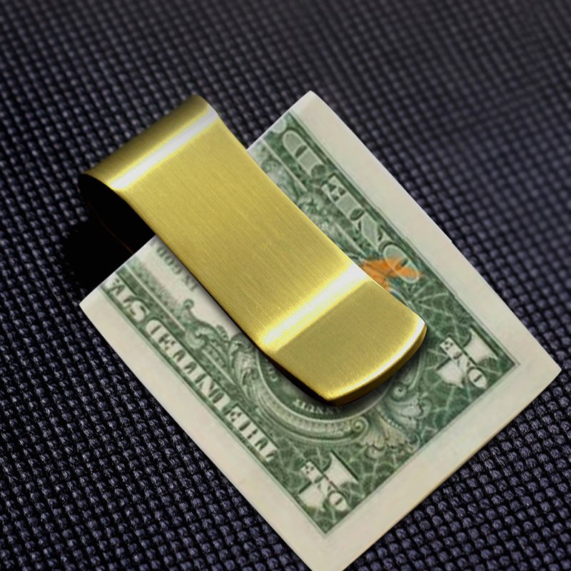 Brass money clip with sleek, polished finish, used as stylish home decor by Fuchsia Molly.