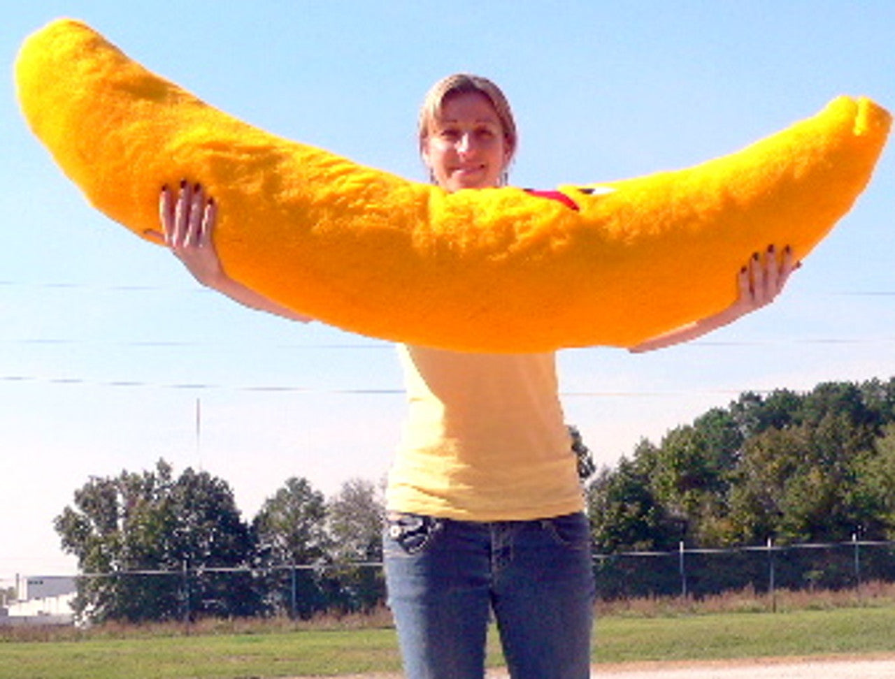 Large 5-foot tall plush banana gift from Ultramarine Eros, soft and vibrant yellow with a friendly, oversized appearance.