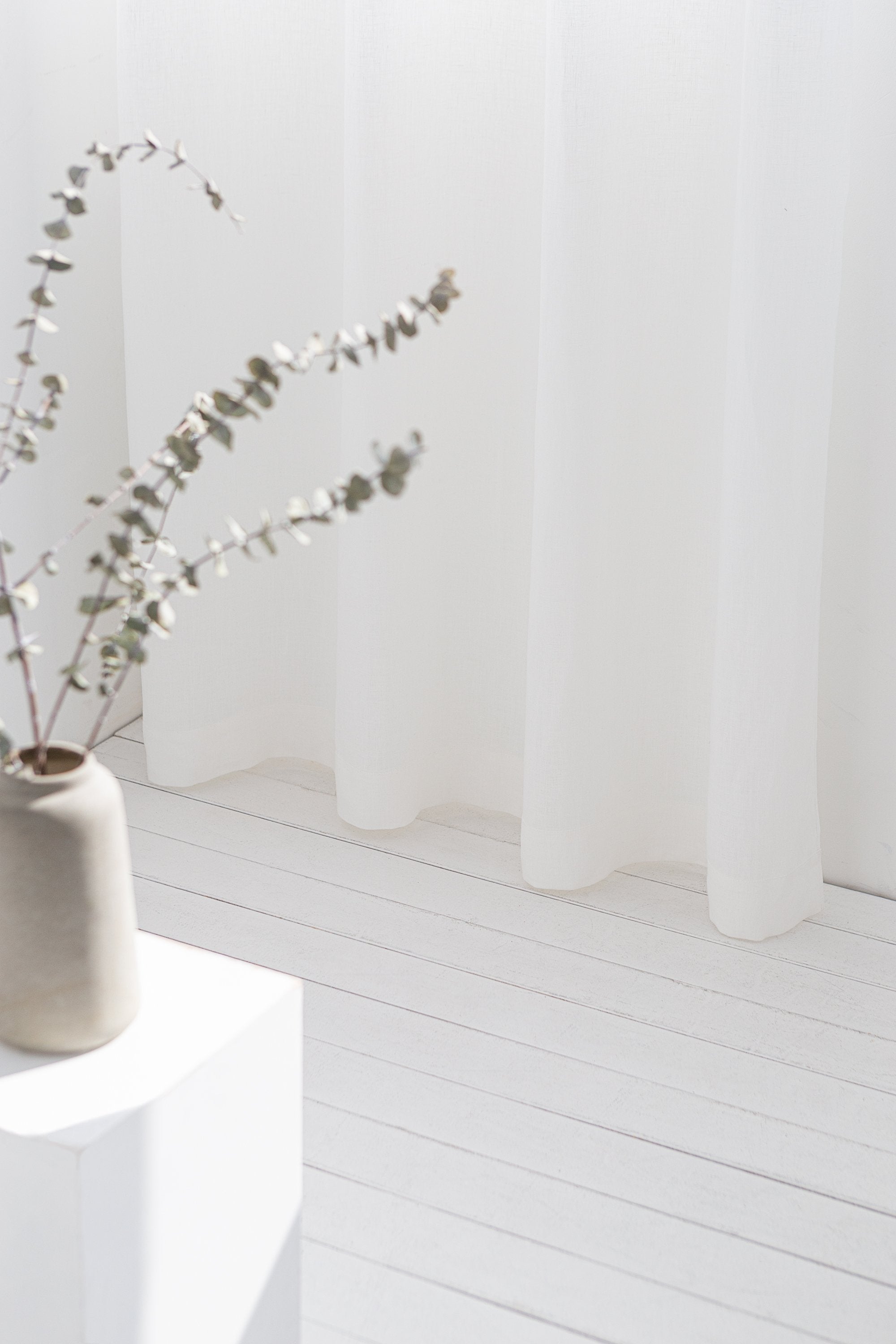 Light grey linen curtain with grommets from Magenta Sugarplum, showcasing a smooth fabric draped with metal grommet top design.