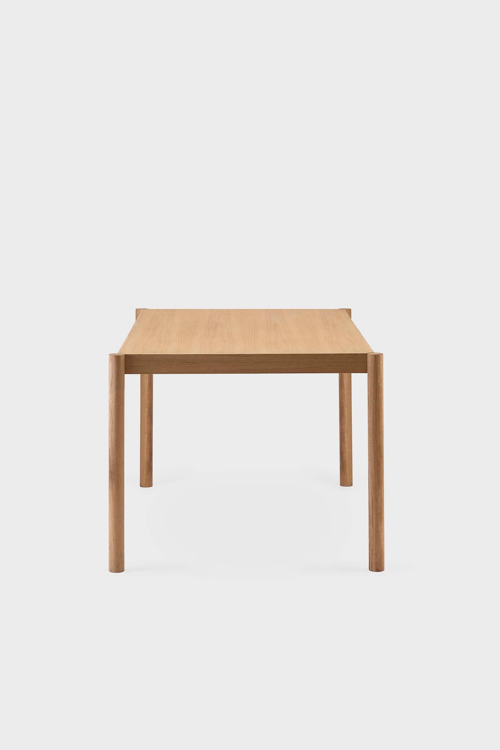 Natural wood Citizen dining table by Aquamarine Poppy, showcasing a modern furniture design with a smooth tabletop and sturdy legs.