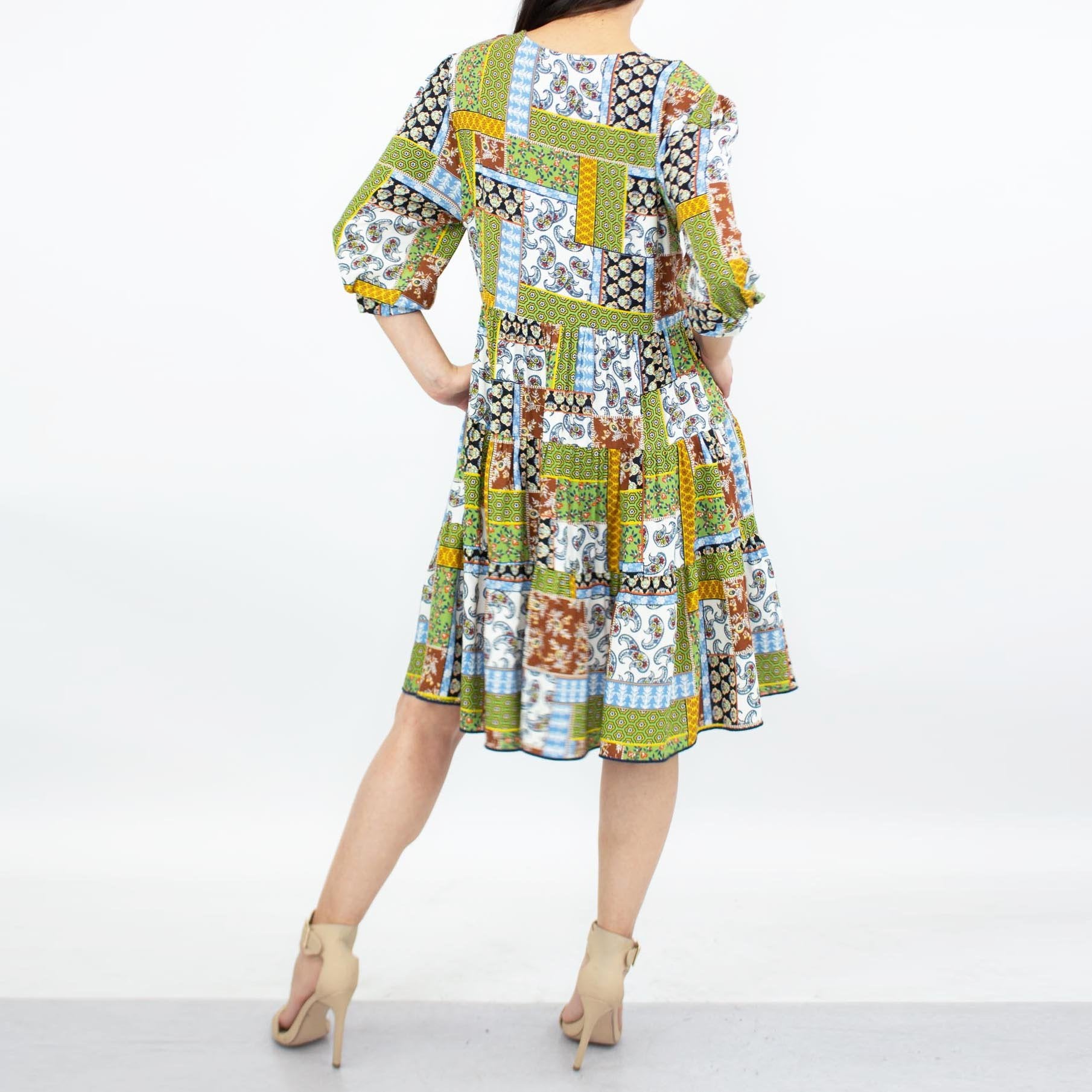 Green flare bottom 3/4 sleeve dress by Yellow Hera, showcasing a stylish and flowy design perfect for casual or semi-formal wear.