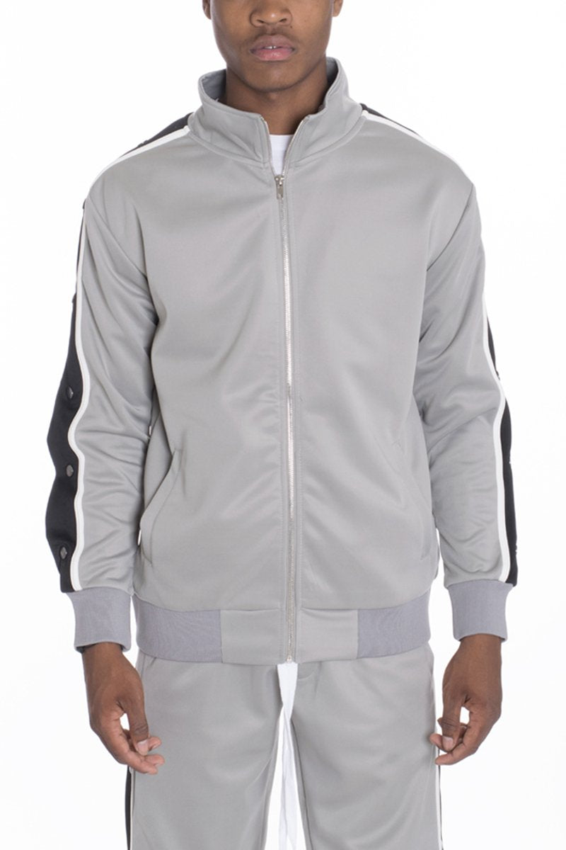 Grey Lime Milo snap button track jacket for women displayed on a hanger, showing front view with snap buttons and sporty design.