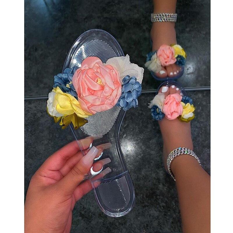 Transparent floral summer slippers for women by Coffee Jasper, featuring colorful flower designs and comfortable slip-on style.