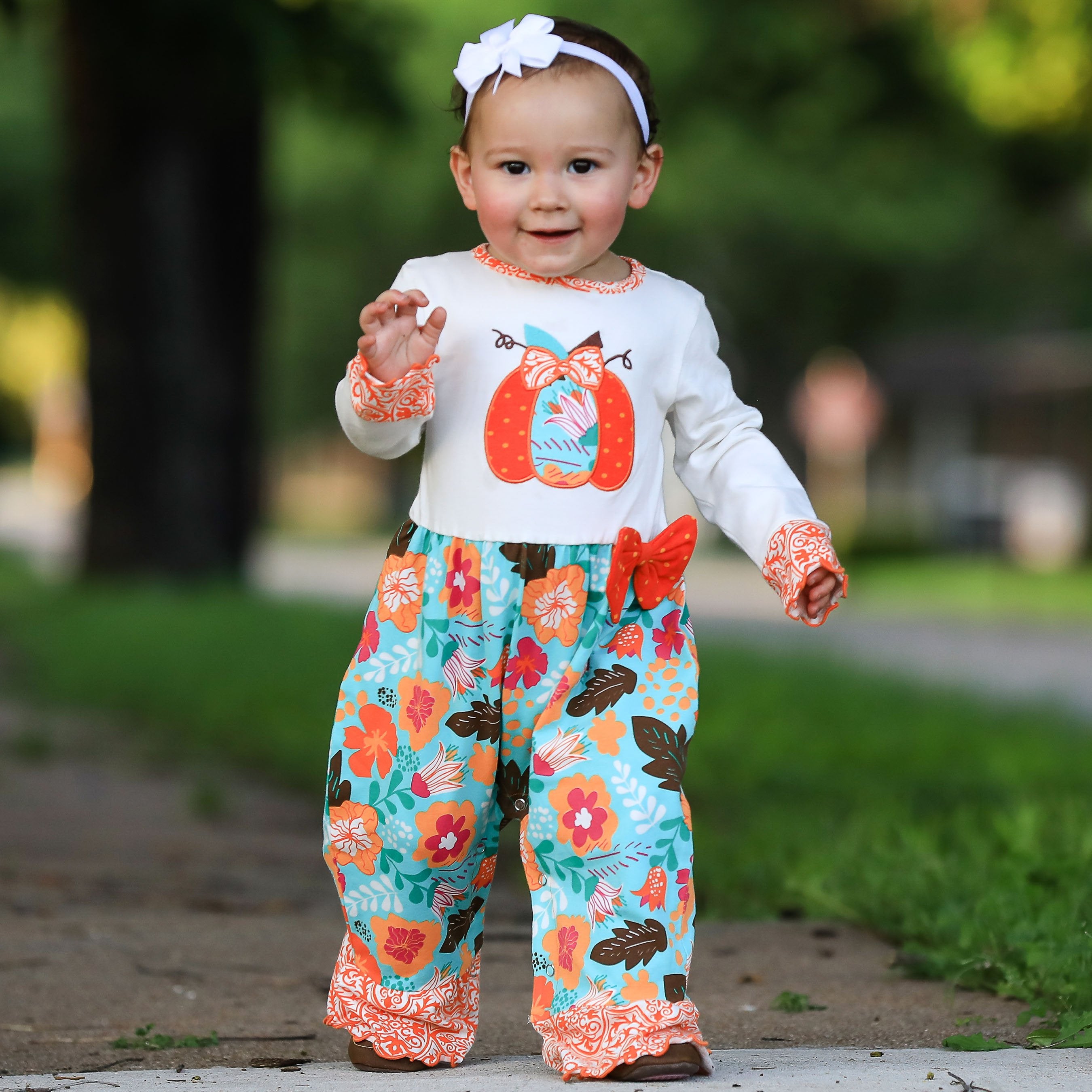 Black Simba AnnLoren baby toddler girls Thanksgiving pumpkin romper with orange autumn-themed pumpkin print, perfect for fall.