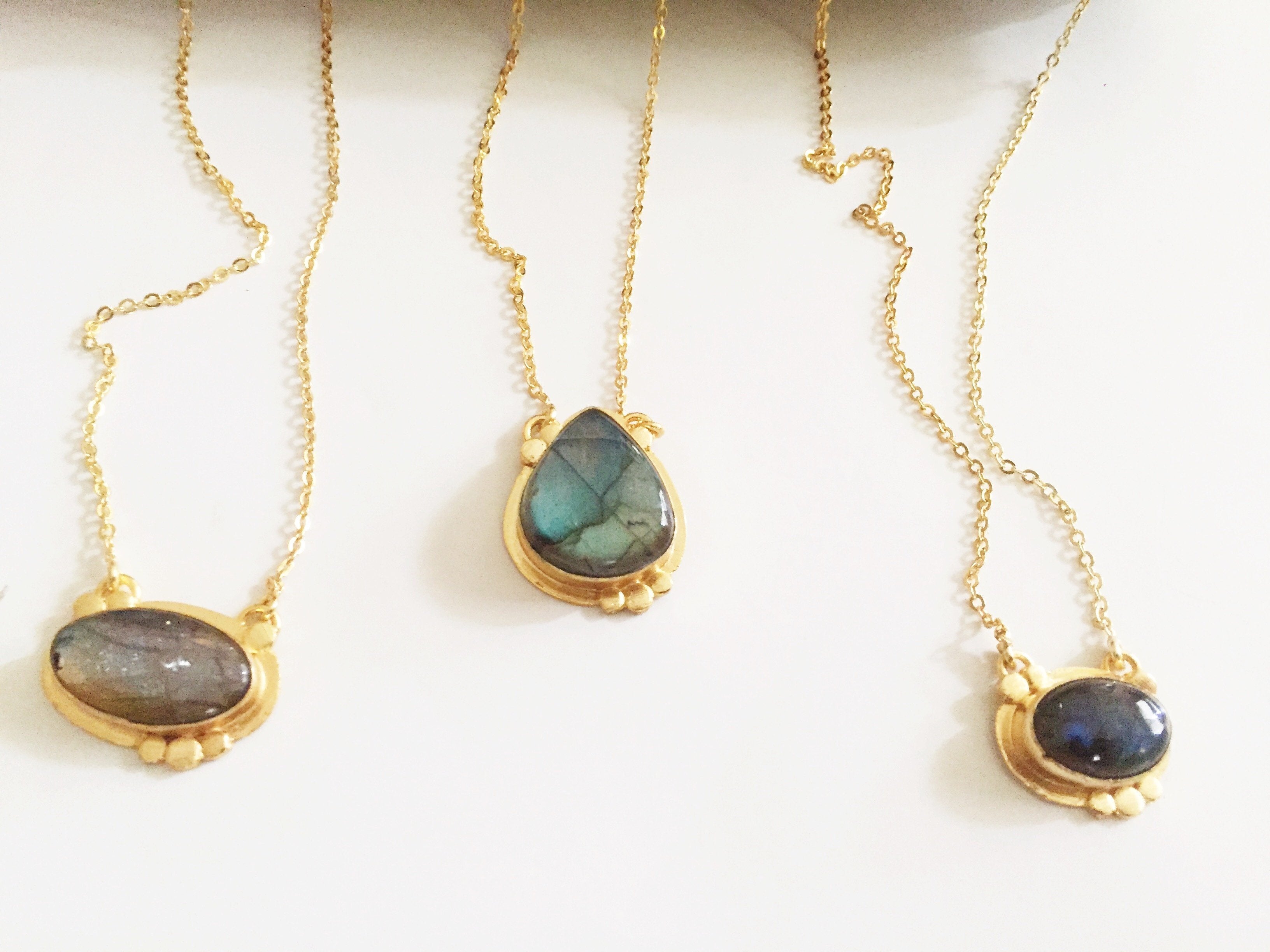 Violet Baobab Agadir Labradorite pendant jewelry featuring a polished labradorite gemstone on a delicate chain.