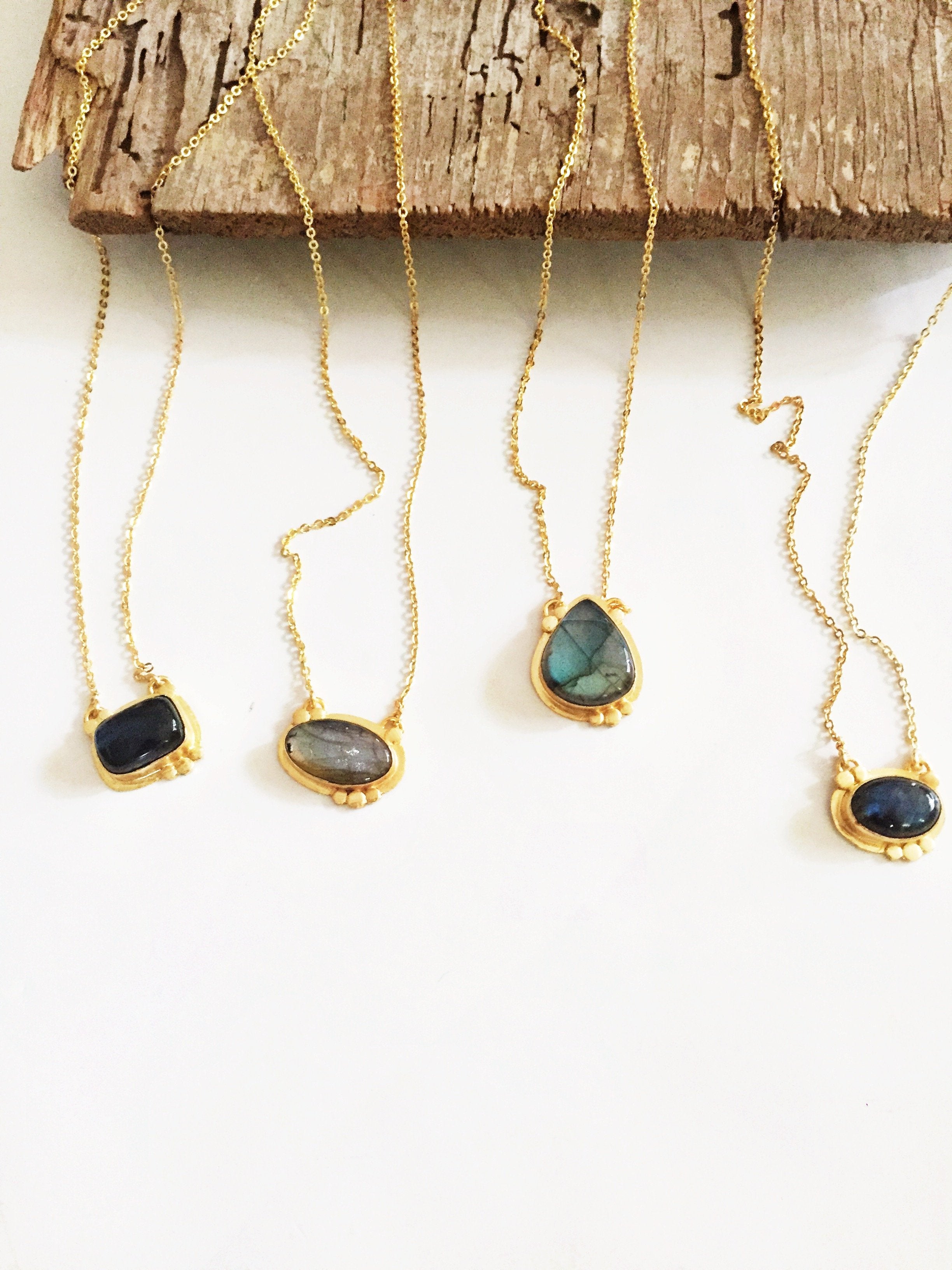 Violet Baobab Agadir Labradorite pendant jewelry featuring a polished labradorite gemstone on a silver chain.