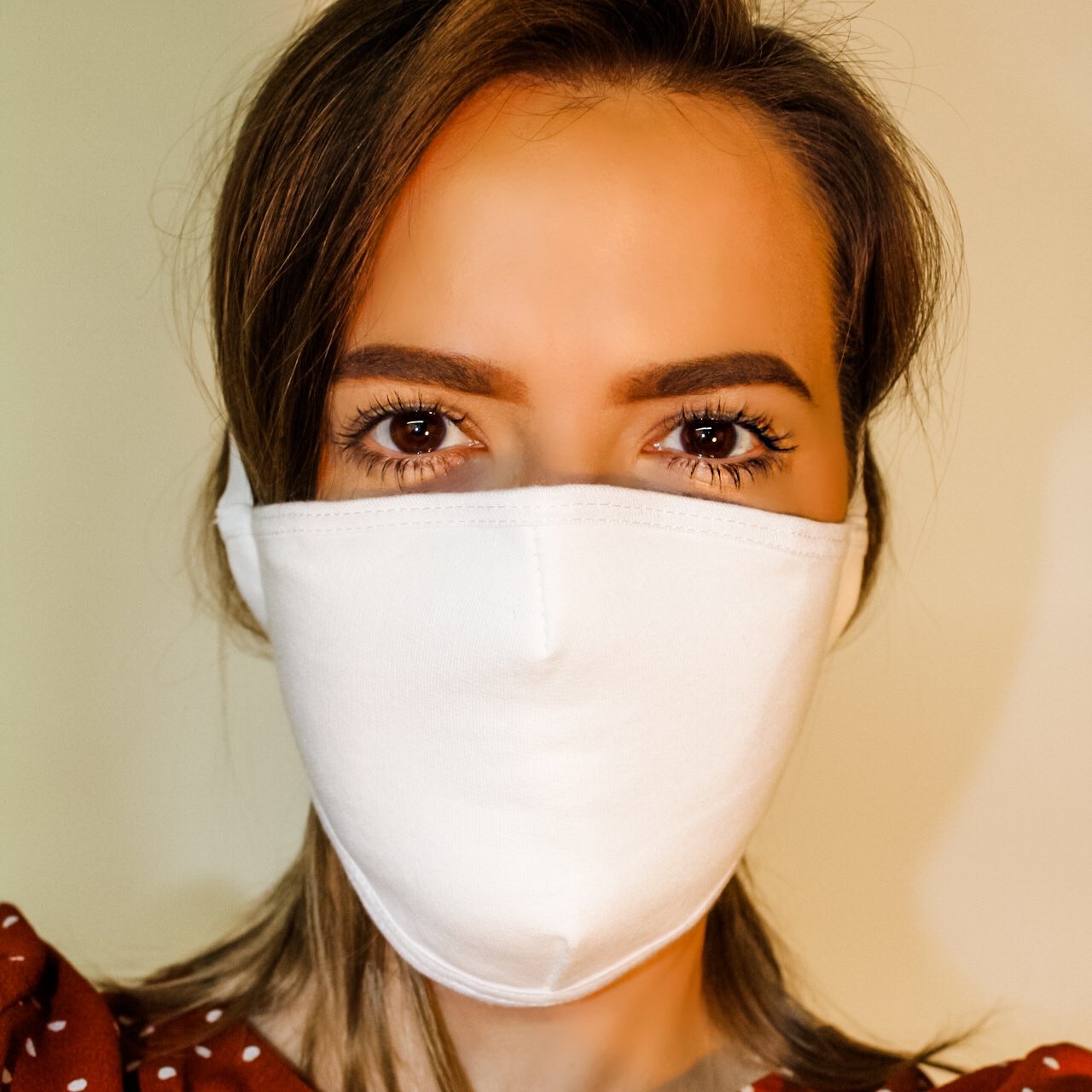 White overhead face mask with filter pocket by Maroon Niobe, healthcare mask made in USA, showing adjustable straps and breathable fabric.
