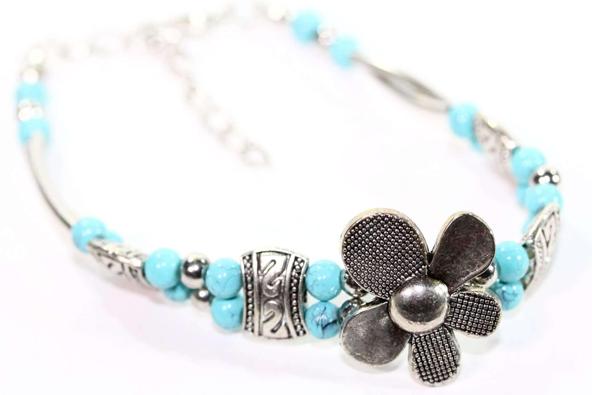 Silver Hestia petal flowers bracelet featuring silver flower charms and delicate chain design, perfect for elegant jewelry styling.