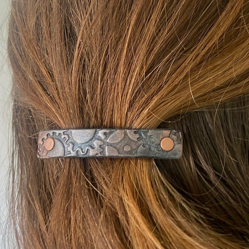 Copper and silver metallic steampunk gear stamped leather hair accessory by Orange Themis, featuring intricate gear designs for hair styling.