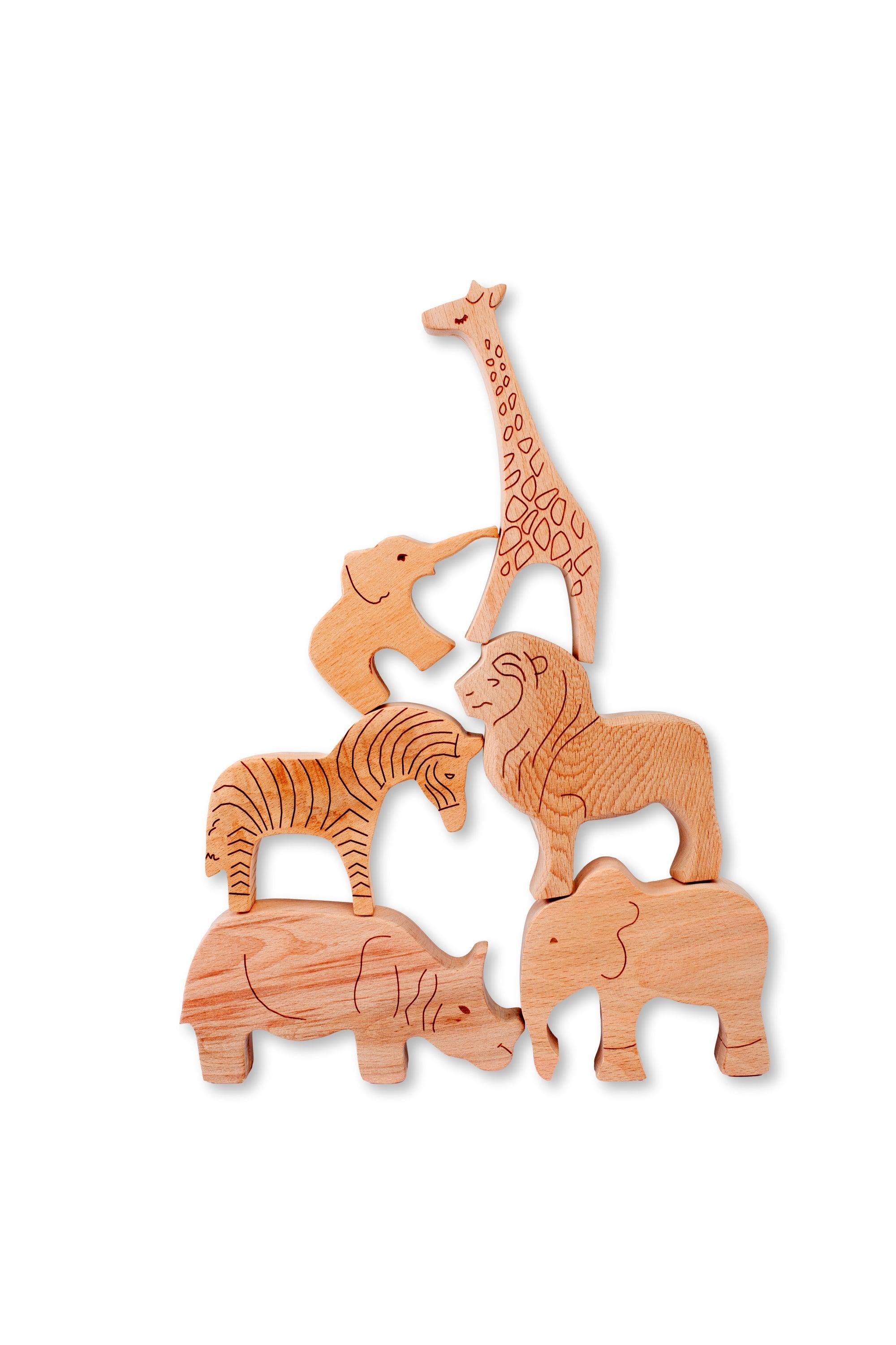 Wooden safari animals set from Red Oceanus furniture, featuring handcrafted wooden animal figures on a natural wood surface.