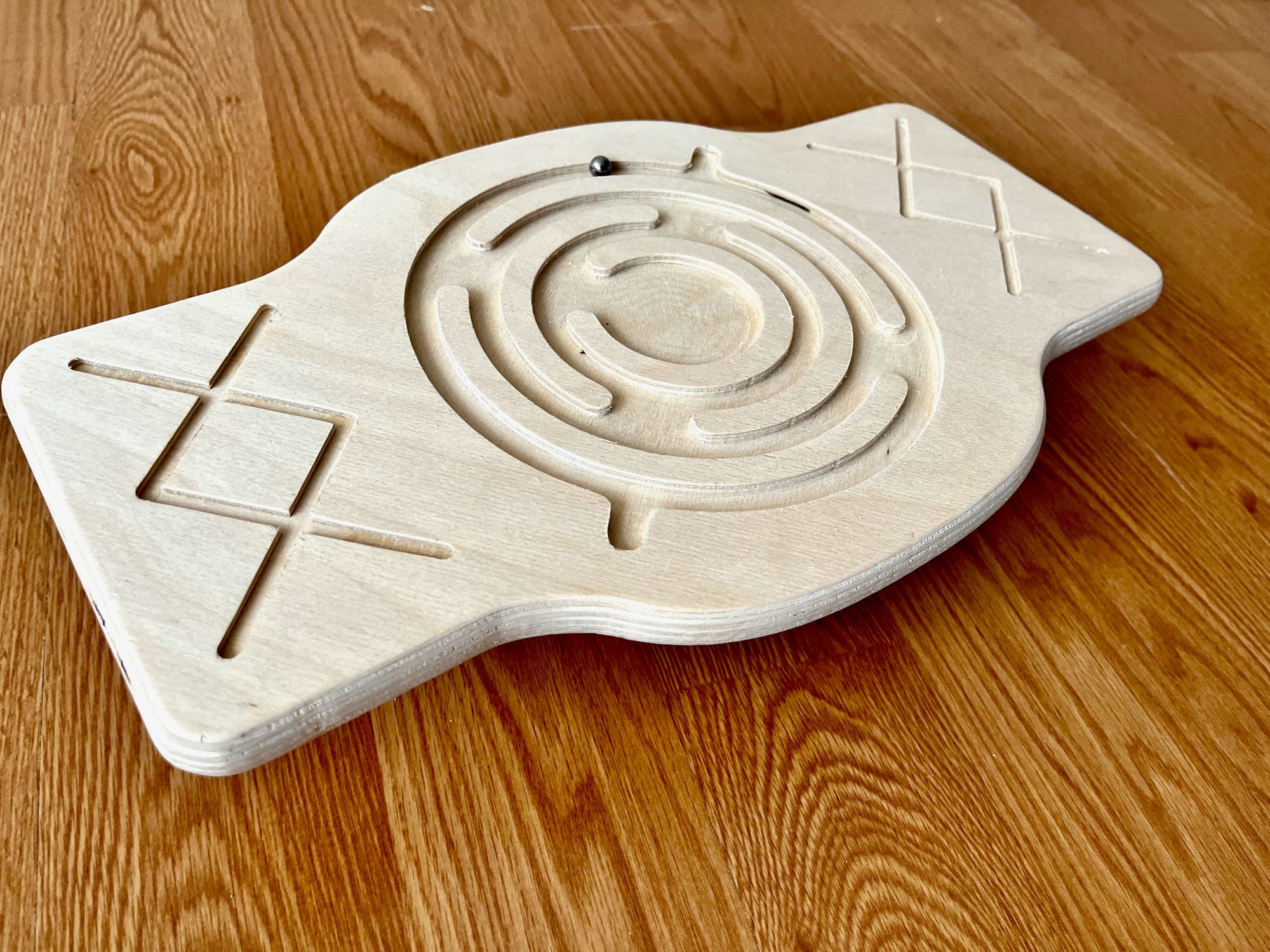 Red Oceanus Maze Wooden Balance Board, a natural wooden furniture piece with a maze design on its surface.