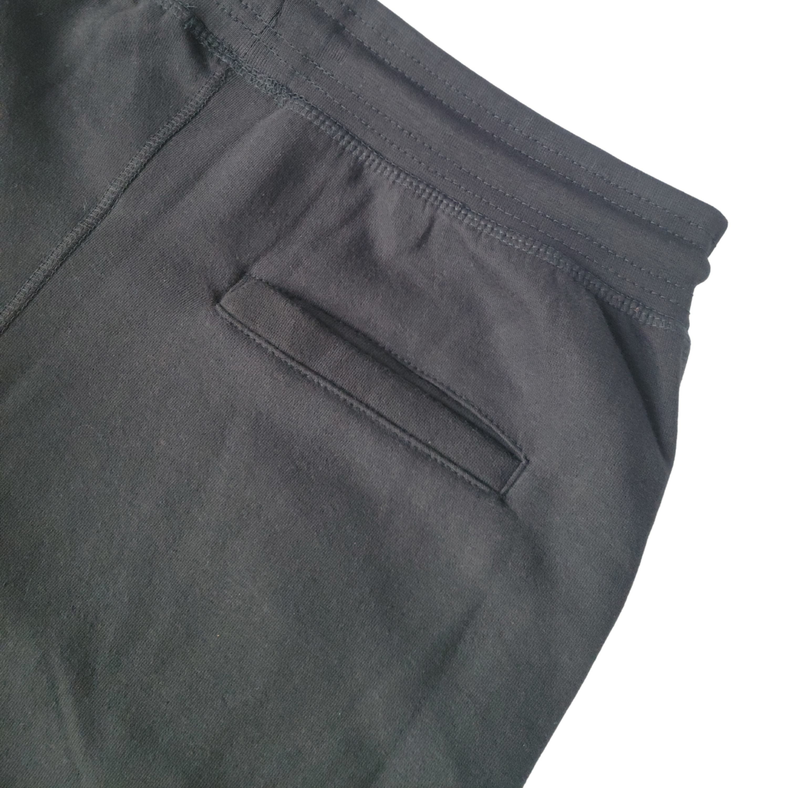 Gray Makade Black Joggers from Grey Trillium, casual sweatpants with elastic waistband and tapered fit, laid flat.