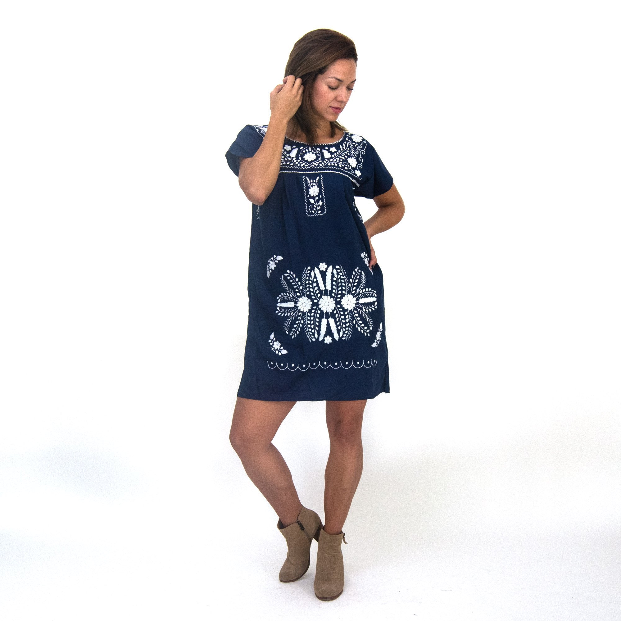 Navy blue boho chic dress with white floral pattern for women, by Violet Athena, displayed on a hanger.