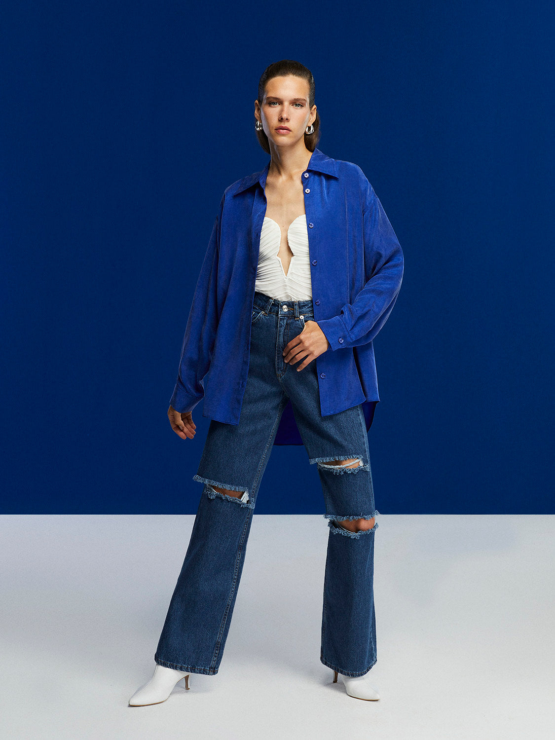 Bronze Aphrodite high-waisted ripped jeans for women, showcasing distressed denim with a fitted waist and trendy style.