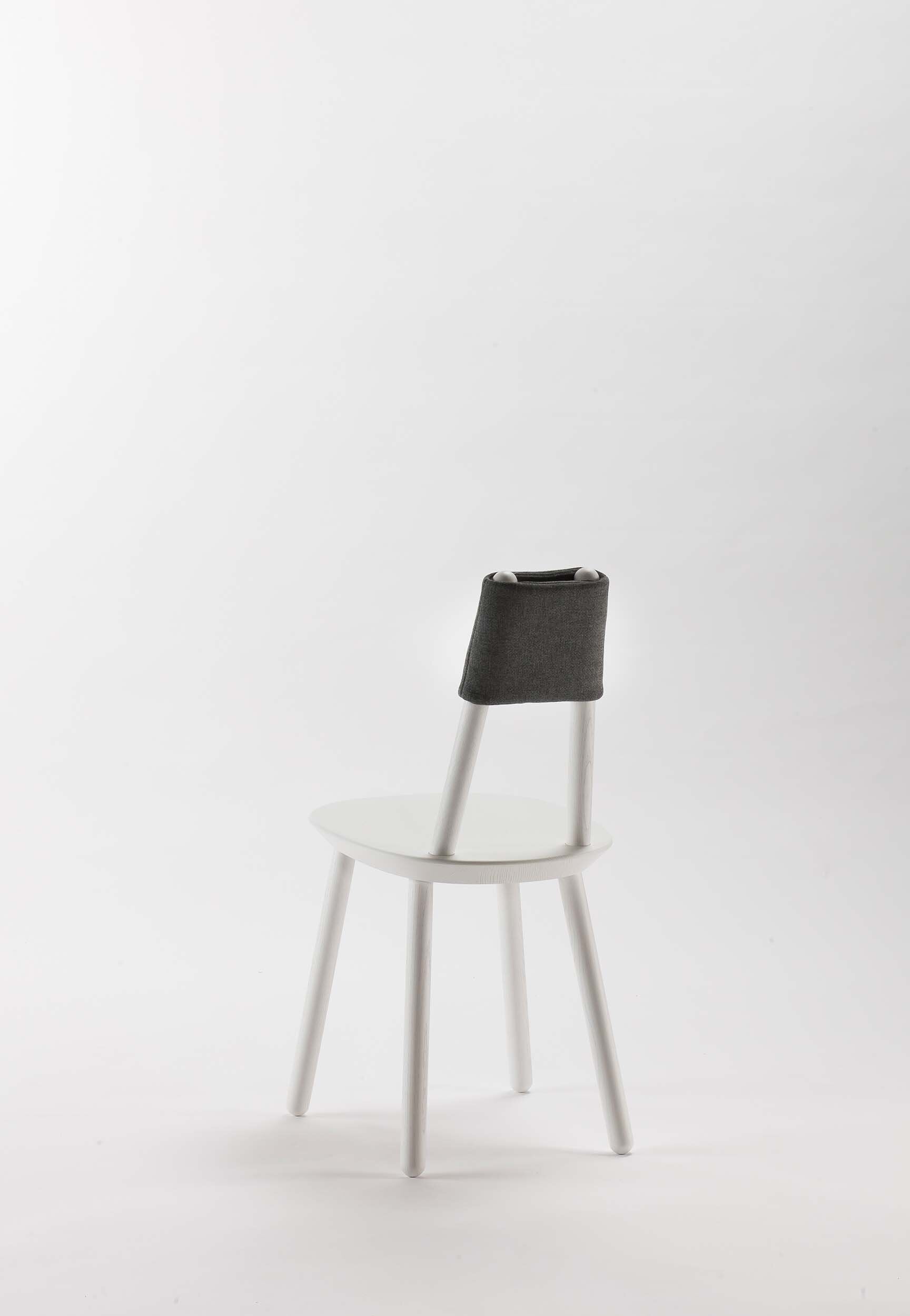 Naïve Dining Chair by Aquamarine Poppy, white furniture with a modern, minimalist design and wooden legs.