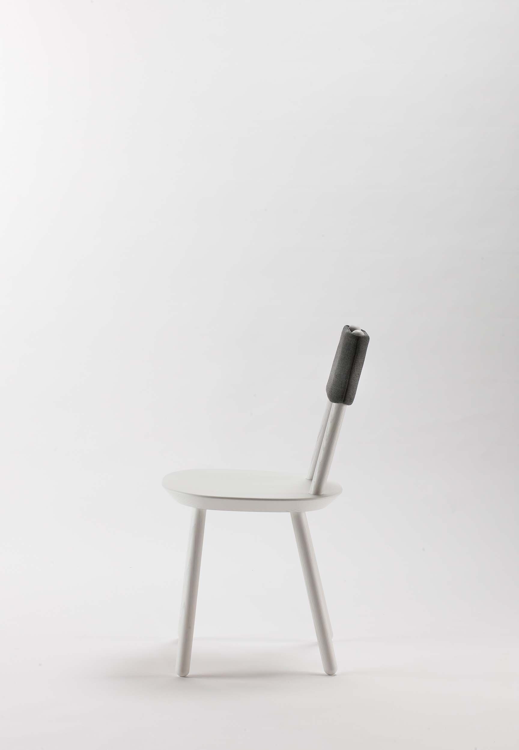White Naïve Dining Chair by Aquamarine Poppy with sleek modern design and smooth wooden legs.