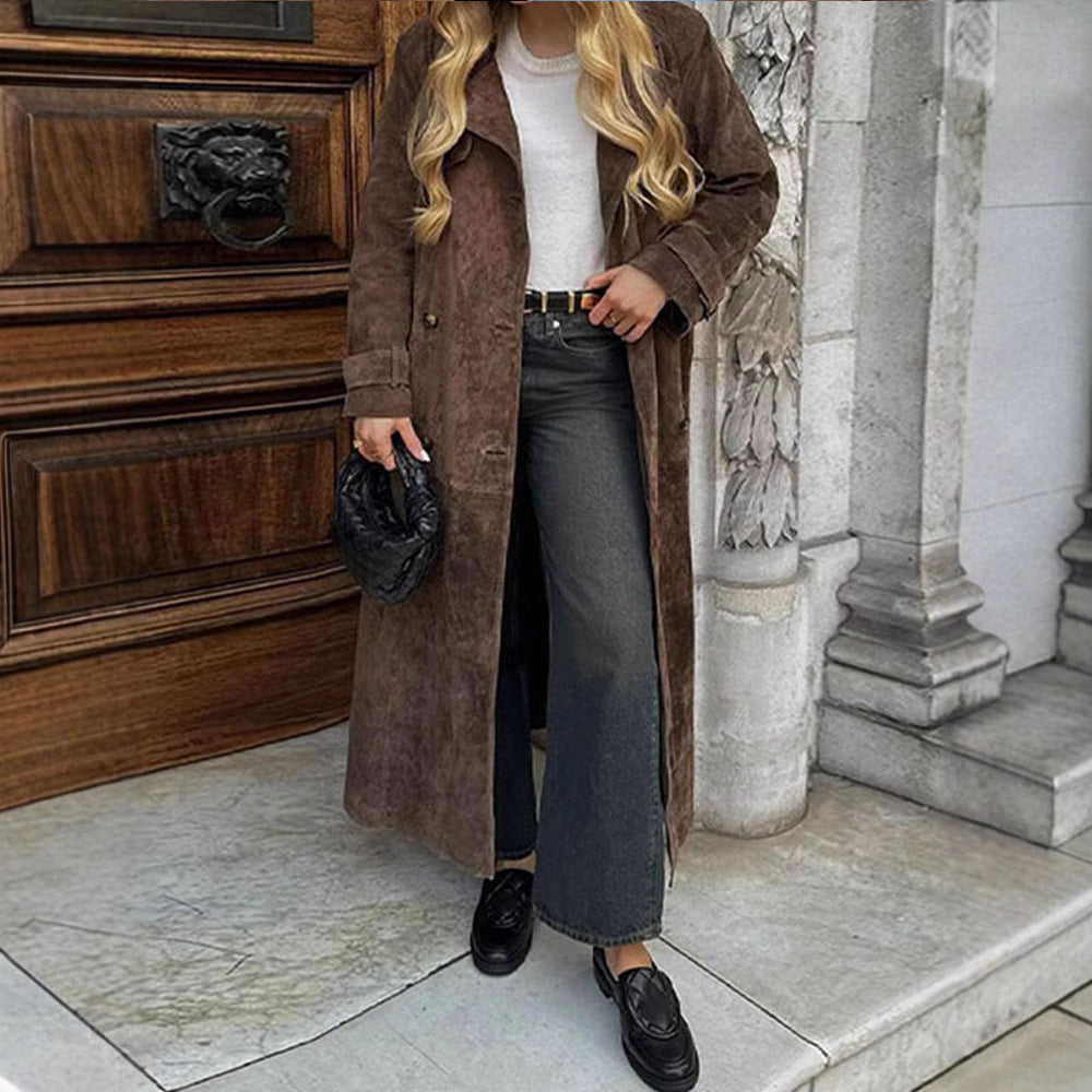 Vintage brown slim coat by Carmine Juneberry, shown on a hanger with detailed fabric texture and tailored design.