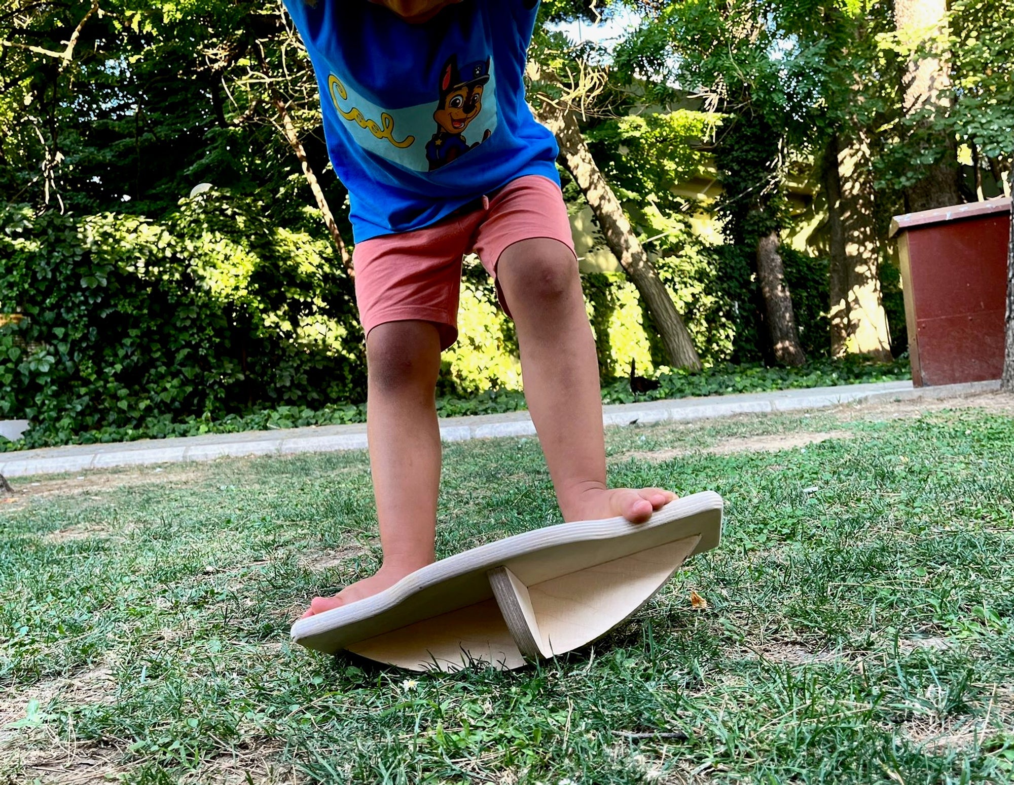 Red Oceanus Maze Wooden Balance Board, a furniture piece with a smooth wooden surface and curved design for stability and balance.