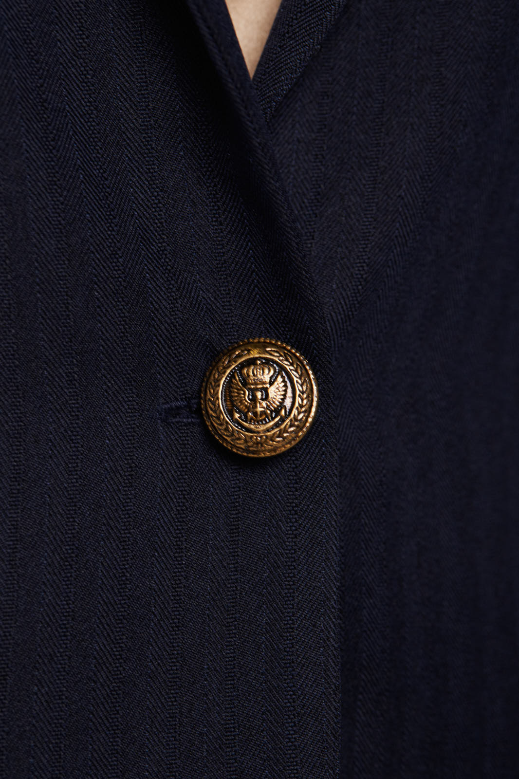 Navy peak-lapels single-breasted tailored blazer for women by Mauve Daisy, shown on a hanger.