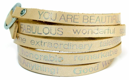 Gold wrap-around bracelet with "You Are Beautiful" inscription by Orange Eunostus, featuring a peaceful, elegant design.