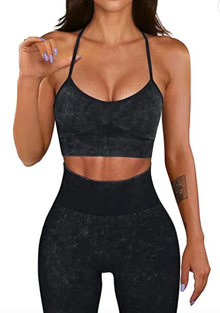 White Amphitryon womenโs activewear set featuring a fitted sports bra and matching leggings for workout and active lifestyle.