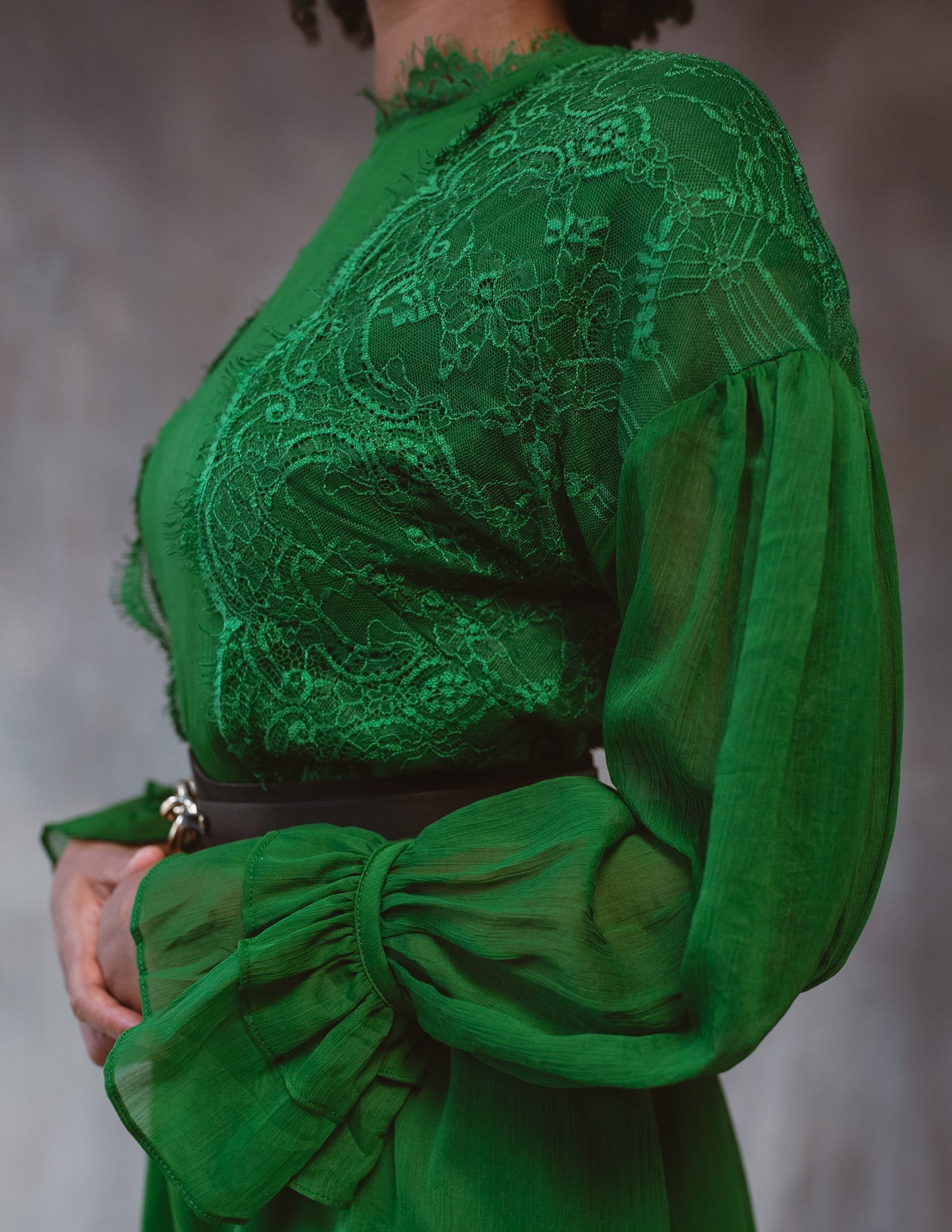 Green lace dress by BethAle London for women, featuring delicate lace fabric and a stylish fit, displayed in a stilllife arrangement.