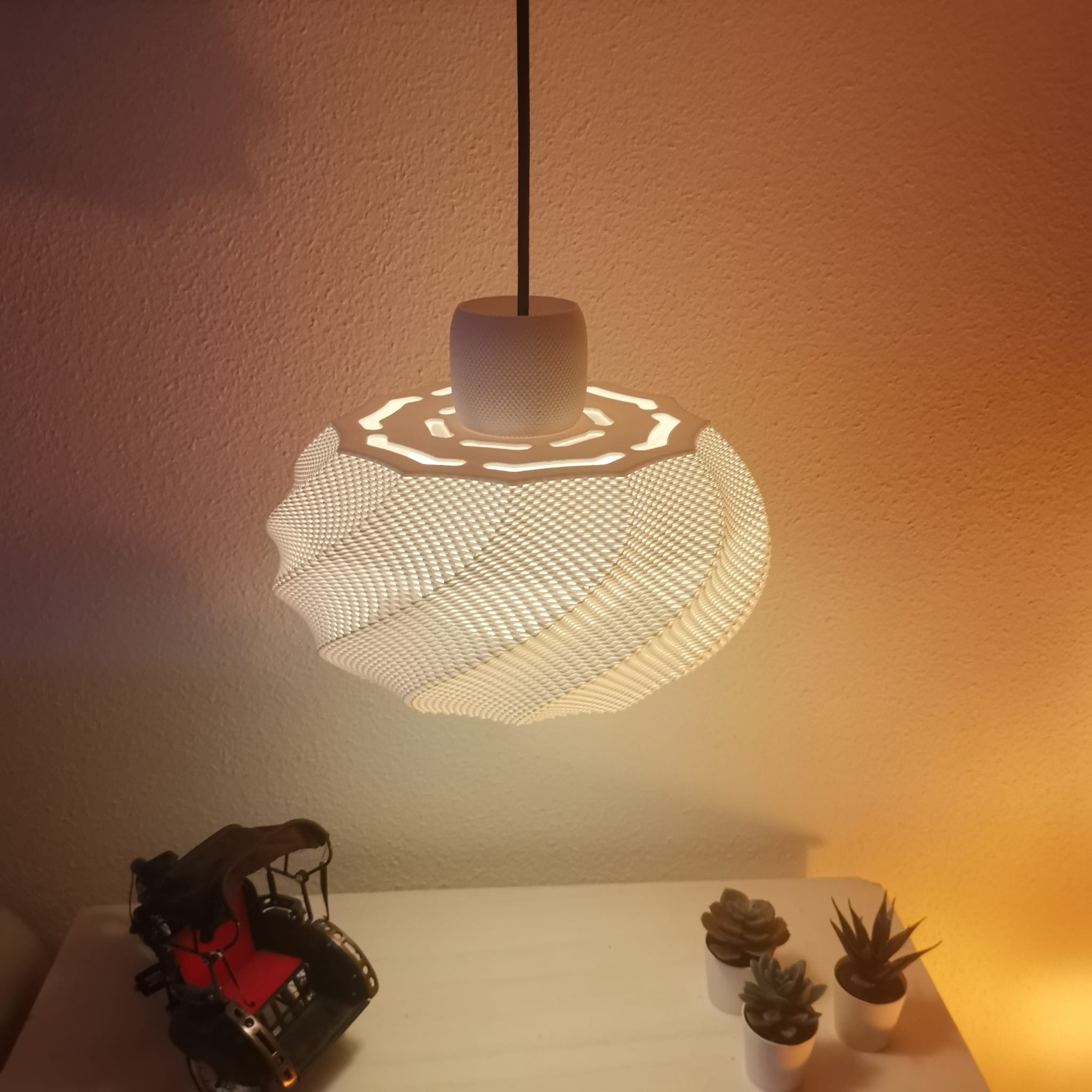 Azure Pontus Twist Glow Pendant Lamp hanging with a softly glowing, modern lighting fixture featuring a twisted design.